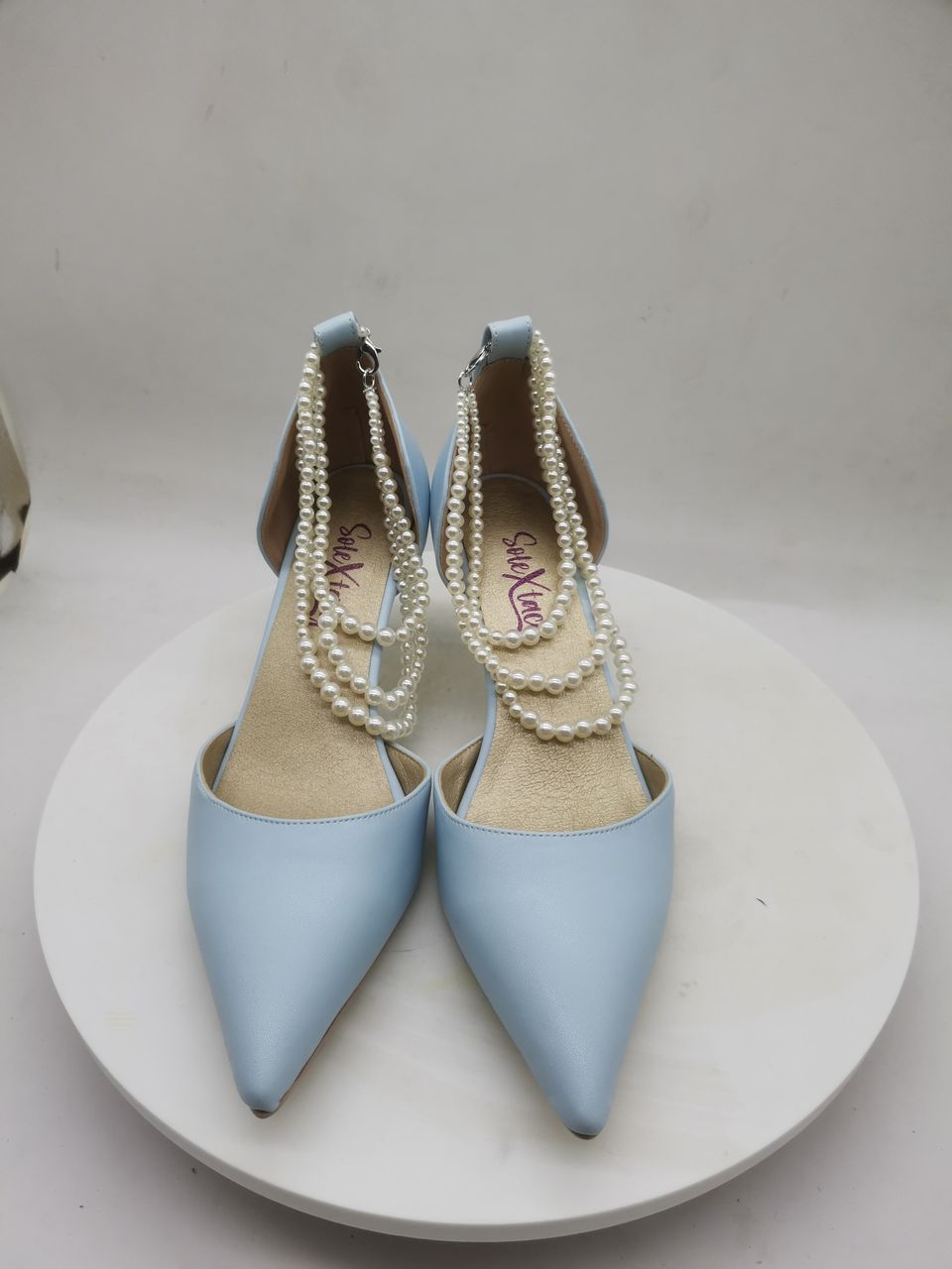 Powder blue pointed heeled pumps with white pearl-bead ankle straps