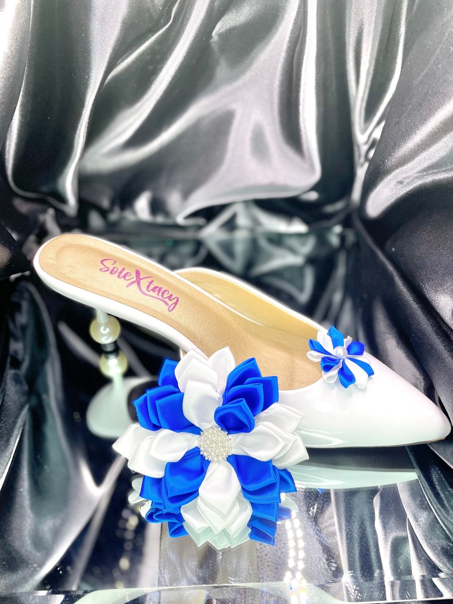 White flats with white and blue Kanzashi flower cluster on the toe