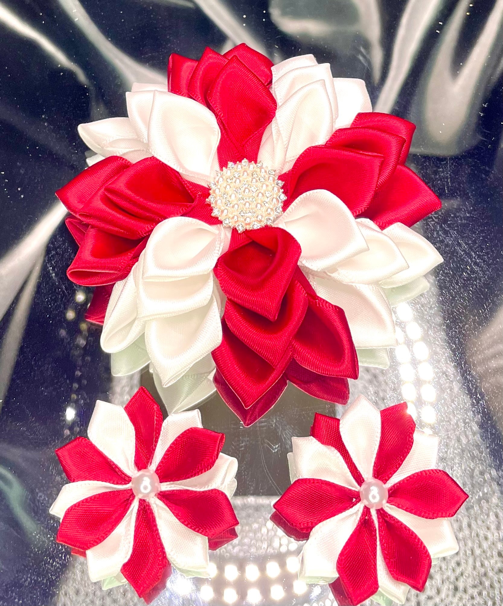 Red and white ribbon kanzashi flower set with three rosettes and pearl centers