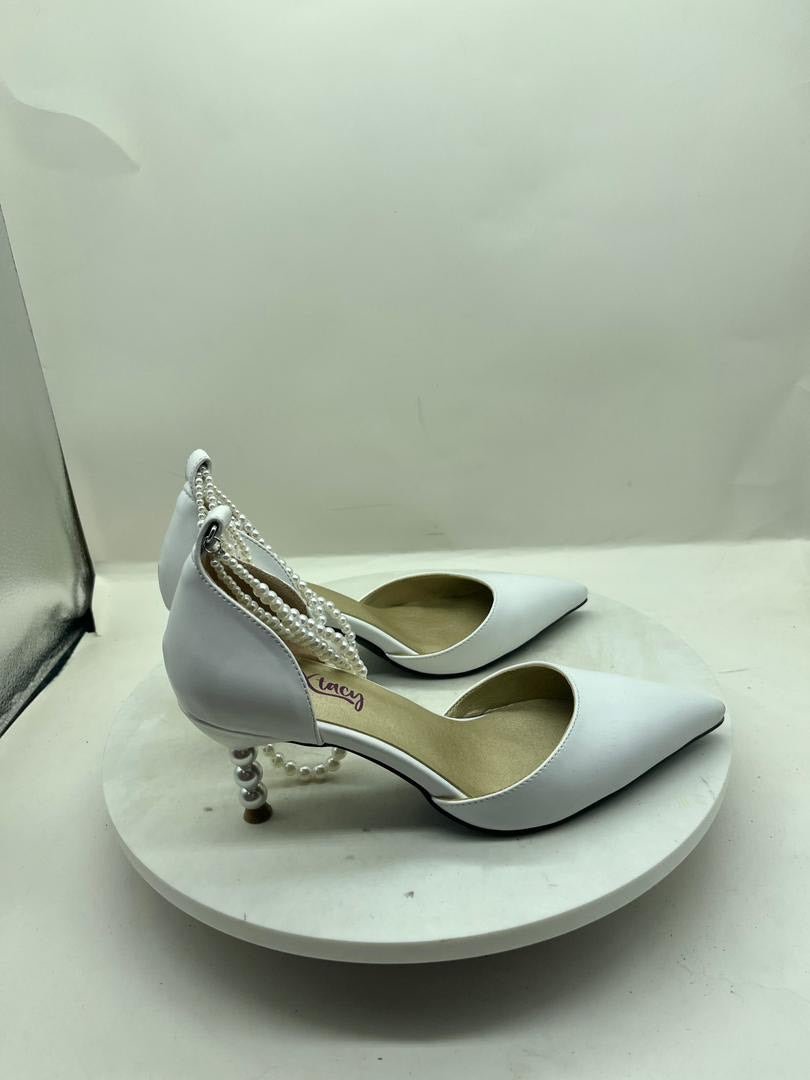 Light blue heeled slingback shoes with white pearl-bead ankle straps and metal heel