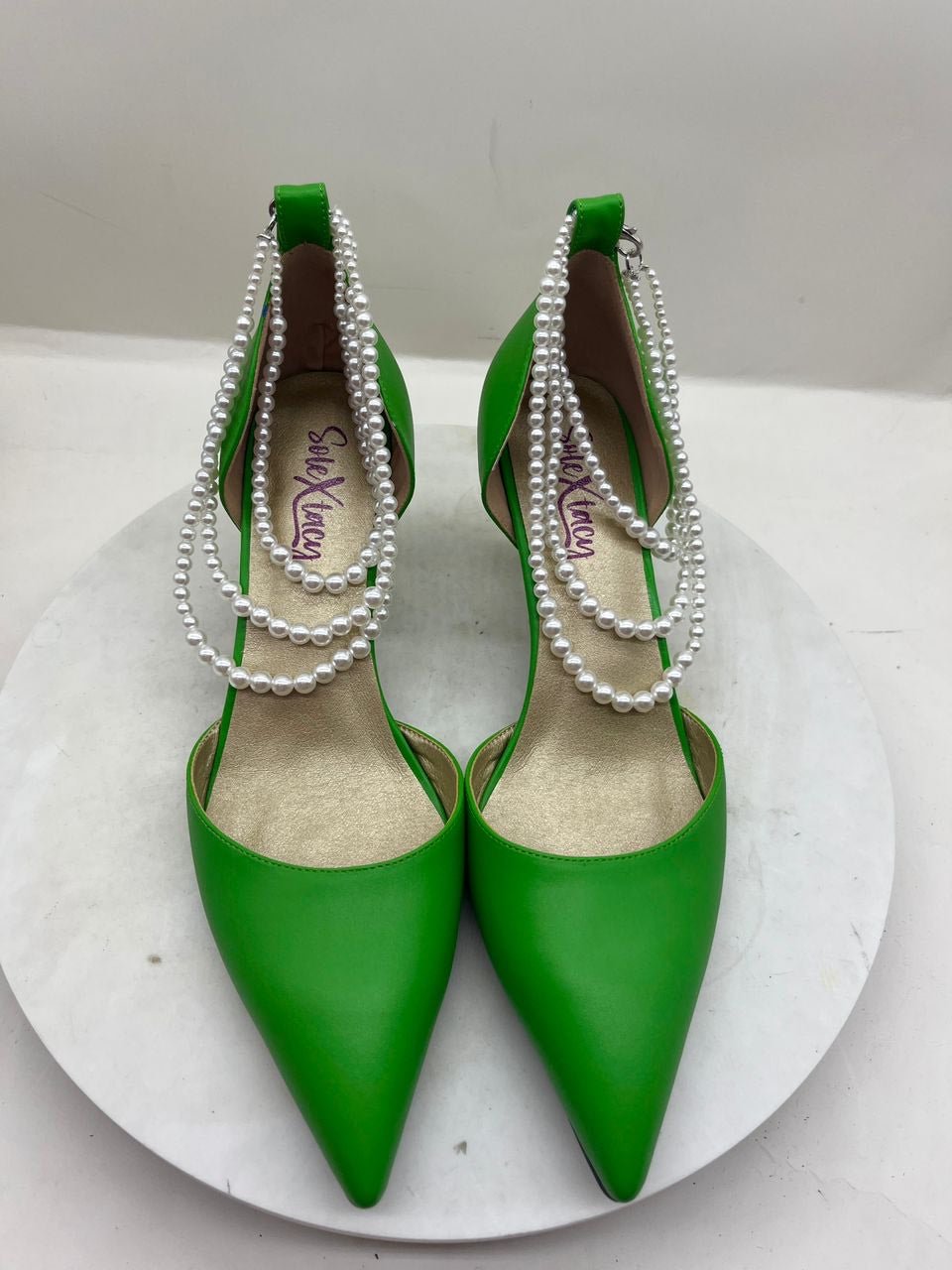 Green pointed-toe stiletto pumps with pearl chain trim and double sling straps