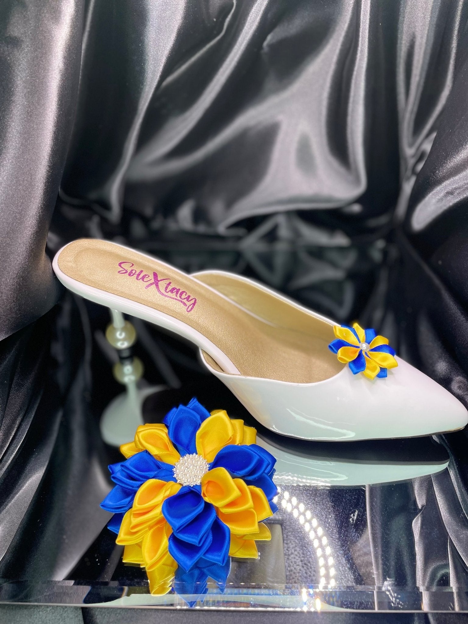 White flats with yellow and blue Kanzashi floral accents on the toe